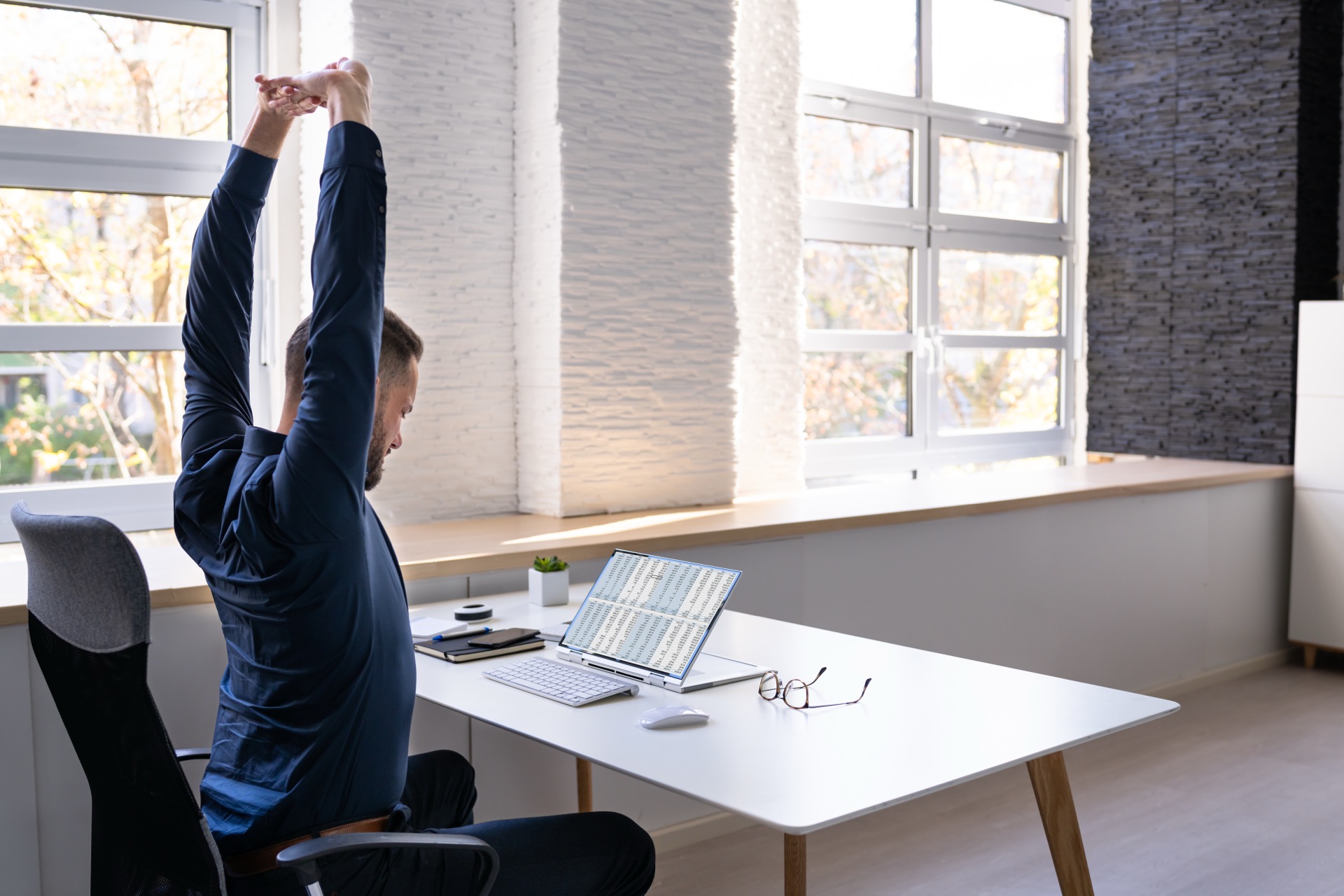 Person stretching at desk